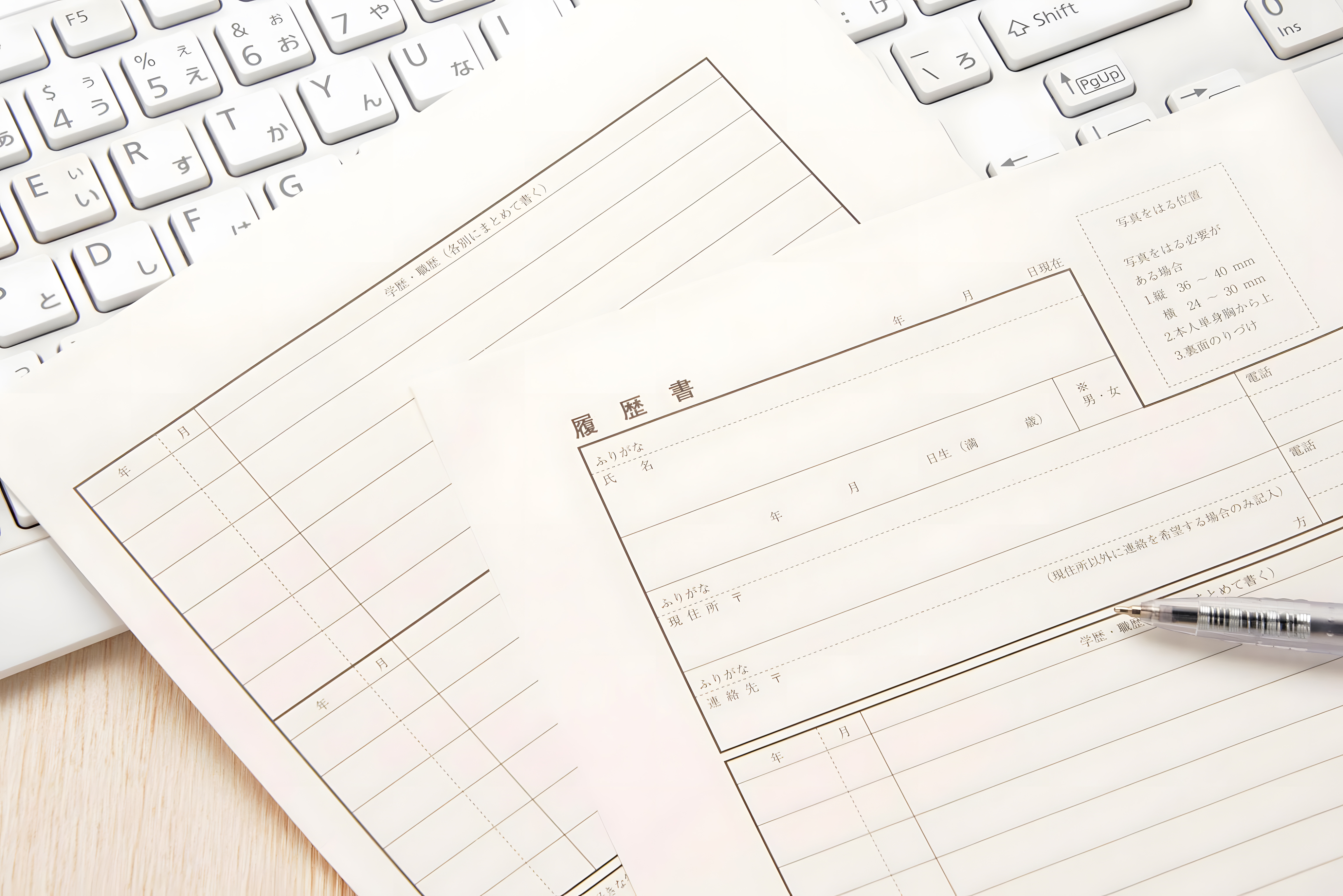 Japanese Resume Form with Pen and Keyboard on Desk